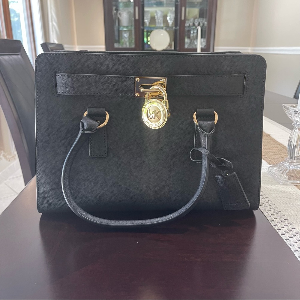 Black Michael Kors bag with a gold chain strap
